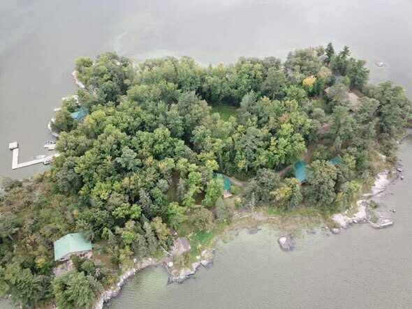 Aerial view of King Island, a wooded 7-acre island ringed by log cottages on Lake of the Woods