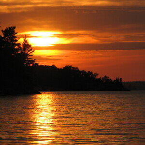 Golden sunset over the calm water of Sabaskong Bay